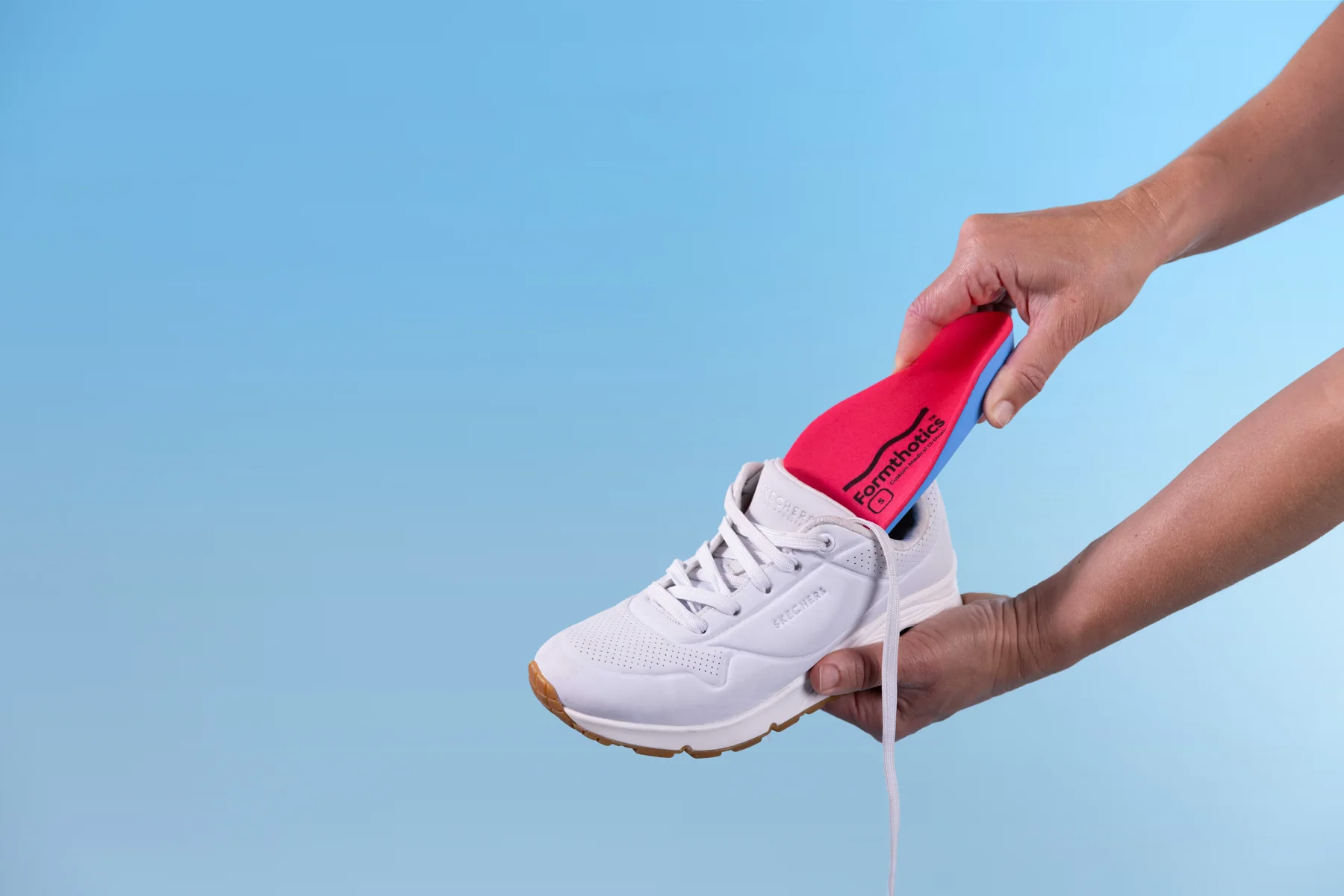 A Formthotics orthotic being placed into a shoe