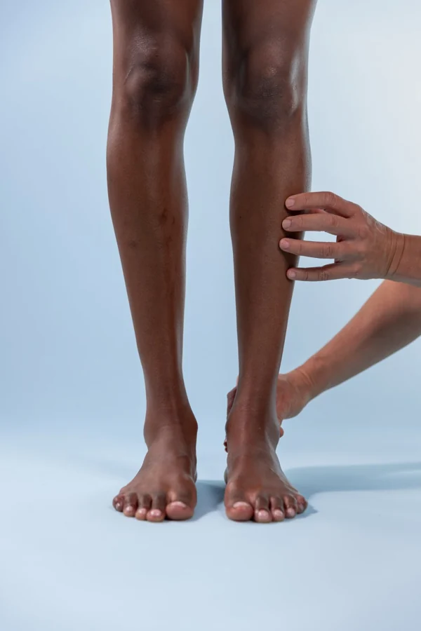 Clinician examining the lower limb in standing